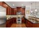 Well-equipped kitchen featuring granite countertops, stainless steel appliances, and wood cabinets at 1403 Ashford Creek Ne Cir, Atlanta, GA 30319