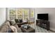 Inviting living room with large windows, comfortable sectional sofa, and stylish decor at 1403 Ashford Creek Ne Cir, Atlanta, GA 30319