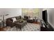Comfortable living room featuring a plush sofa, ottoman, and stylish patterned rug at 1403 Ashford Creek Ne Cir, Atlanta, GA 30319