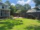 Large, grassy backyard with wooden fence, garden, and landscaping at 1725 Spindle Top Sw Ct, Lilburn, GA 30047