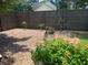 View of gravel backyard featuring a privacy fence and potted flowers at 1725 Spindle Top Sw Ct, Lilburn, GA 30047