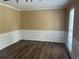 Dining room features classic wainscoting, wood floors, and neutral colored walls at 1725 Spindle Top Sw Ct, Lilburn, GA 30047