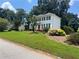 Charming two-story home with a red front door and lush front lawn at 1725 Spindle Top Sw Ct, Lilburn, GA 30047