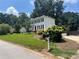 A two-story home with a manicured lawn and landscaping, plus a detached garage at 1725 Spindle Top Sw Ct, Lilburn, GA 30047