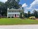 Charming two-story home with a well-manicured lawn, bright red door, and classic black shutters at 1725 Spindle Top Sw Ct, Lilburn, GA 30047