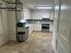 Well-lit kitchen featuring white cabinets and stainless steel appliances with vinyl flooring at 1725 Spindle Top Sw Ct, Lilburn, GA 30047