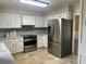 Bright kitchen featuring stainless steel appliances, white cabinets, and ample counter space at 1725 Spindle Top Sw Ct, Lilburn, GA 30047