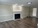 Bright living room with dark wood floors, neutral paint, and a fireplace with white mantel at 1725 Spindle Top Sw Ct, Lilburn, GA 30047