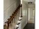 Elegant staircase with dark wood banister and white painted trim in a well-lit hallway at 1725 Spindle Top Sw Ct, Lilburn, GA 30047