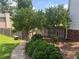 Landscaped yard with trees and bushes adjacent to a wooden fence at 1725 Spindle Top Sw Ct, Lilburn, GA 30047