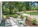 Patio featuring outdoor seating with a view of the green backyard and driveway at 4103 Statewood Ne Rd, Atlanta, GA 30342