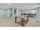 Finished basement featuring bar and ping pong table, wood look flooring, and light blue walls at 4103 Statewood Ne Rd, Atlanta, GA 30342