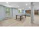Large finished basement with light colored floors, ping pong table, exposed duct work, and bar with door to outside at 4103 Statewood Ne Rd, Atlanta, GA 30342