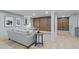 Finished basement featuring stylish wood paneled walls, light colored floors, and neutral paint with a gray sofa and decor at 4103 Statewood Ne Rd, Atlanta, GA 30342