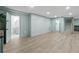 Large, versatile basement space boasts updated flooring, convenient access to a full bathroom, and staircase at 4103 Statewood Ne Rd, Atlanta, GA 30342