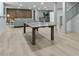 Spacious finished basement with wood paneled wall, light colored floors, ping pong table, and bar area at 4103 Statewood Ne Rd, Atlanta, GA 30342