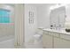 Clean bathroom featuring tiled walls and floors, and shower behind curtain at 4103 Statewood Ne Rd, Atlanta, GA 30342