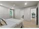Bright bedroom featuring built-in closet, light hardwood floors, view into bath and sitting area at 4103 Statewood Ne Rd, Atlanta, GA 30342