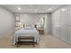 Bright bedroom featuring built-in closet, light hardwood floors and a bench in front of the bed at 4103 Statewood Ne Rd, Atlanta, GA 30342