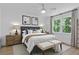 Well-lit bedroom with large bed, bench, decorative artwork, and lots of natural light at 4103 Statewood Ne Rd, Atlanta, GA 30342