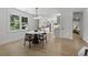Sunlit dining area adjacent to the kitchen featuring modern furnishings and lovely views of the outdoor scenery at 4103 Statewood Ne Rd, Atlanta, GA 30342
