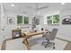 Inviting home office with modern desk, chair, shelving, and windows offering natural light, complemented by neutral decor at 4103 Statewood Ne Rd, Atlanta, GA 30342