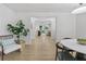 Open-concept living room with white walls, light hardwood floors, and view into another room at 4103 Statewood Ne Rd, Atlanta, GA 30342