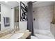 Well-lit bathroom featuring a granite countertop, framed mirror, and shower-tub combination with tile surround at 855 Peachtree Ne St # 3005, Atlanta, GA 30308
