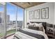 Chic bedroom with city views, modern artwork, luxurious bedding, and ample natural light at 855 Peachtree Ne St # 3005, Atlanta, GA 30308