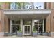 Contemporary apartment building entrance with glass doors, greenery, and clear signage: Viewpoint Condominiums at 855 Peachtree Ne St # 3005, Atlanta, GA 30308