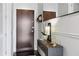 Modern condo entryway featuring dark wood floors, minimalist console table, and stylish wall decor at 855 Peachtree Ne St # 3005, Atlanta, GA 30308