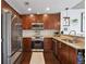 Modern kitchen with stainless steel appliances, granite countertops, dark wood cabinets, and hardwood floors at 855 Peachtree Ne St # 3005, Atlanta, GA 30308