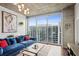 Bright, modern living room with a large window offering city views, comfortable seating, and stylish decor at 855 Peachtree Ne St # 3005, Atlanta, GA 30308