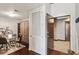Open living space with dark hardwood floors, murphy bed, dining table and entry to bedroom at 855 Peachtree Ne St # 3005, Atlanta, GA 30308