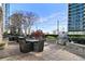 Outdoor lounge area featuring comfortable seating, dining tables, and grill with greenery and city views at 855 Peachtree Ne St # 3005, Atlanta, GA 30308