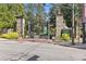 Entrance to Piedmont Park with stone pillars, iron gates, lush greenery, and pedestrian crosswalk at 855 Peachtree Ne St # 3005, Atlanta, GA 30308