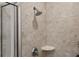 Bathroom tile shower with adjustable shower head, mounted accessories, and glass door at 855 Peachtree Ne St # 3005, Atlanta, GA 30308