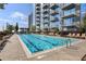 Relaxing outdoor swimming pool area with lounging chairs near a modern condo building at 855 Peachtree Ne St # 3005, Atlanta, GA 30308