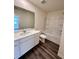 Bathroom featuring a vanity with sink and a shower-tub combo at 133 Bandimere Pkwy, Dallas, GA 30157