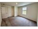 Bedroom with gray carpeting, double door closet, neutral paint, and a window allowing for natural light at 133 Bandimere Pkwy, Dallas, GA 30157