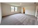 Empty bedroom with carpeting, white walls, a double door closet and two large windows at 133 Bandimere Pkwy, Dallas, GA 30157