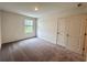 Bright bedroom with neutral carpeting and a window for natural light at 133 Bandimere Pkwy, Dallas, GA 30157