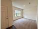 Inviting entryway featuring neutral carpet, a front door, and a window for natural light at 133 Bandimere Pkwy, Dallas, GA 30157