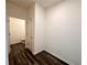 Hallway with wood floors leading to the half-bathroom at 133 Bandimere Pkwy, Dallas, GA 30157