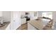 Bright kitchen features granite countertops, white cabinets, stainless appliances, and an island with seating at 133 Bandimere Pkwy, Dallas, GA 30157