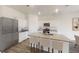 Kitchen boasts granite countertops, white cabinets, an island with seating and stainless steel appliances at 133 Bandimere Pkwy, Dallas, GA 30157