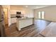 Open kitchen featuring an island with granite countertops, white cabinets, and stainless steel appliances at 133 Bandimere Pkwy, Dallas, GA 30157