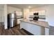 Modern kitchen featuring granite countertops, white cabinets, stainless appliances and an island with sink at 133 Bandimere Pkwy, Dallas, GA 30157