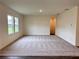 Spacious living room area with large windows, wood flooring, and neutral paint, ready for customization at 133 Bandimere Pkwy, Dallas, GA 30157