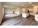 Open-concept living room featuring hardwood floors, neutral carpet and a kitchen with stainless appliances at 133 Bandimere Pkwy, Dallas, GA 30157